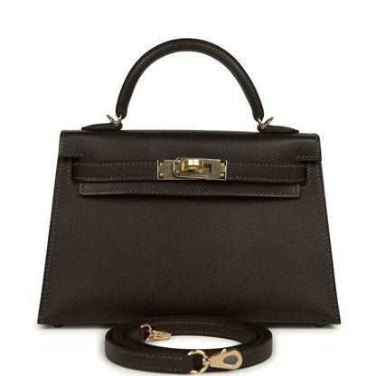 Dark leather mini top-handle bag with gold-tone turn-lock front and strap