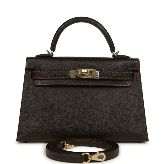 Dark leather mini top-handle bag with gold-tone turn-lock front and strap