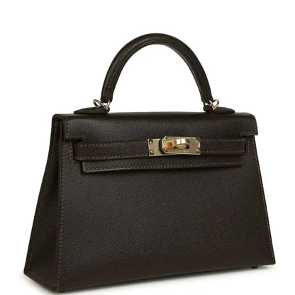 Dark leather mini top-handle bag with gold-tone front clasp and curved handles