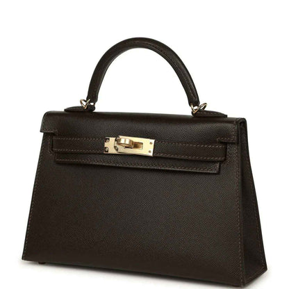 Dark leather mini top-handle bag with gold-tone turn-lock clasp on front flap