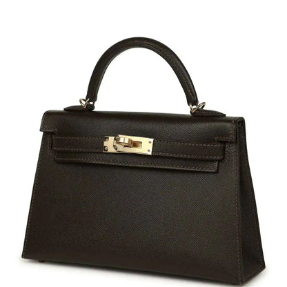 Dark leather mini top-handle bag with gold-tone turn-lock clasp on front flap