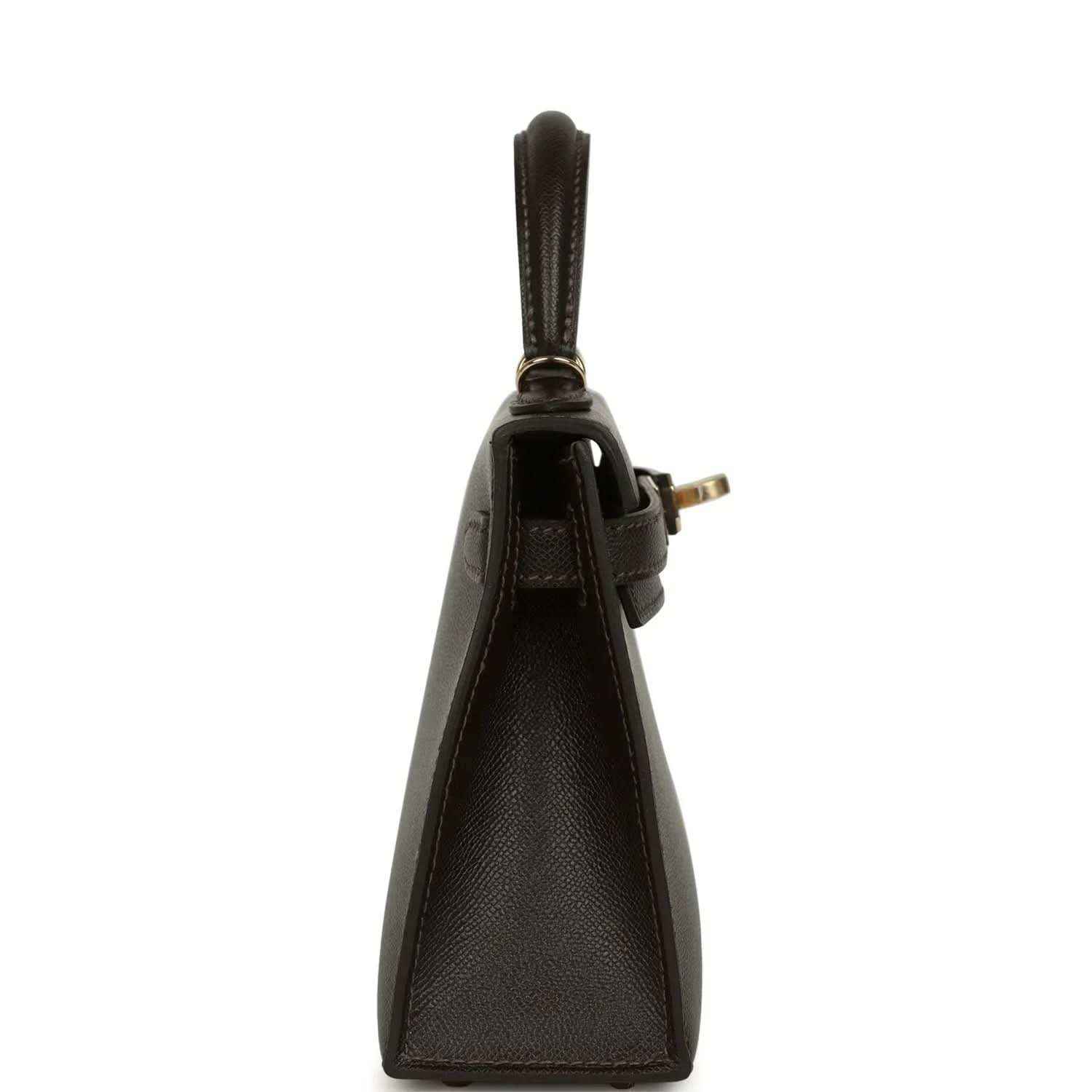 Dark leather mini handbag with short handle and gold-tone hardware at side