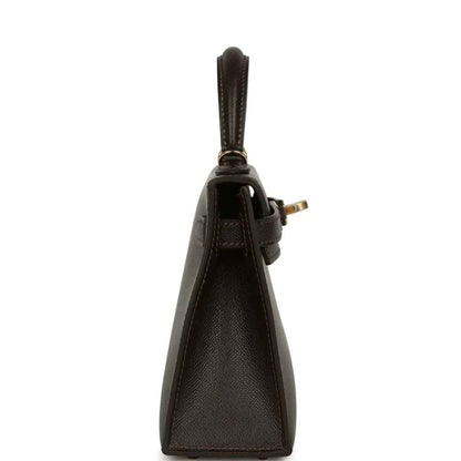Dark leather mini handbag with short handle and gold-tone hardware at side