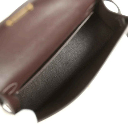 Dark leather interior of a mini bag with smooth lining and curved edge
