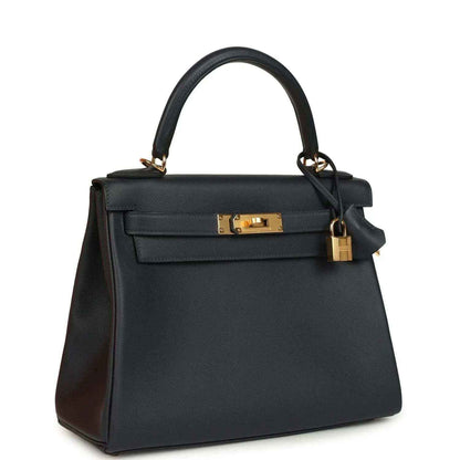 Hermes Kelly Retourne 28 handbag, dark navy leather, gold lock hardware, top handles.