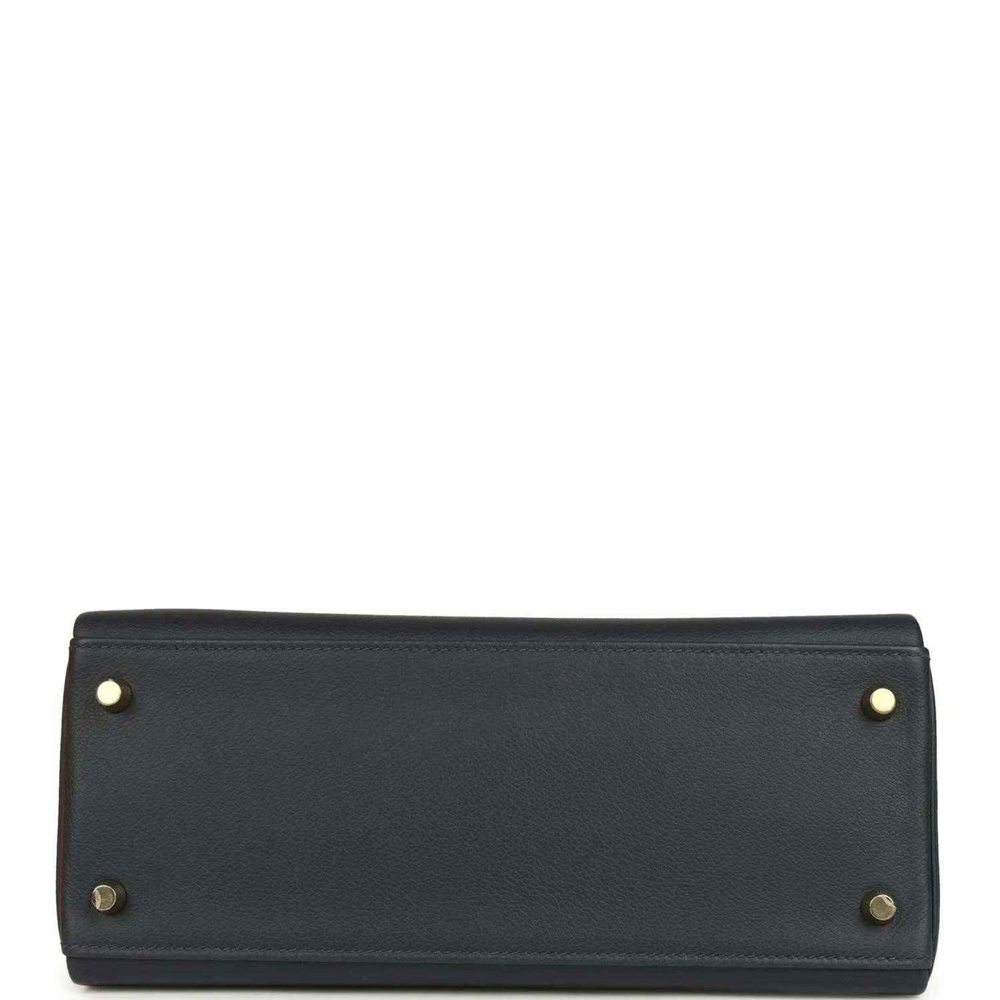 Hermes Kelly Retourne 28 handbag base, dark navy leather, gold corner studs, flat bottom.