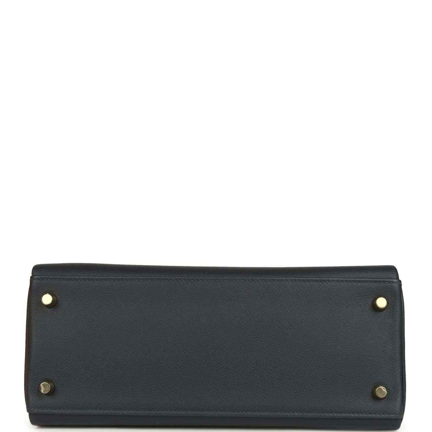 Hermes Kelly Retourne 28 handbag base, dark navy leather, gold corner studs, flat bottom.