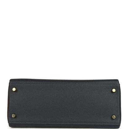 Hermes Kelly Retourne 28 handbag base, dark navy leather, gold corner studs, flat bottom.