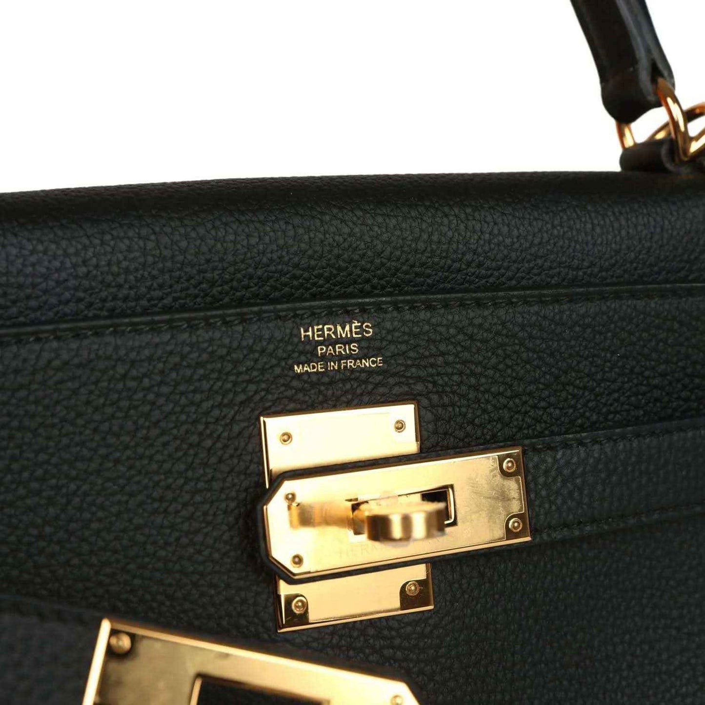 Hermes Kelly Retourne handbag detail, gold turnlock hardware with Hermes Paris markings