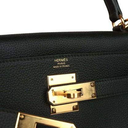 Hermes Kelly Retourne handbag detail, gold turnlock hardware with Hermes Paris markings