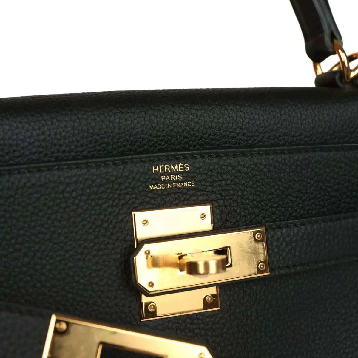 Hermes Kelly Retourne handbag detail, gold turnlock hardware with Hermes Paris markings