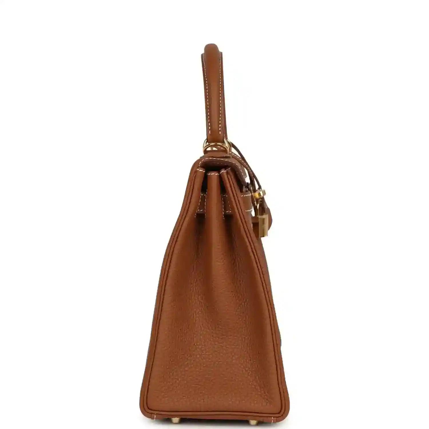 Tan brown leather handbag side view with structured sides and gold hardware feet