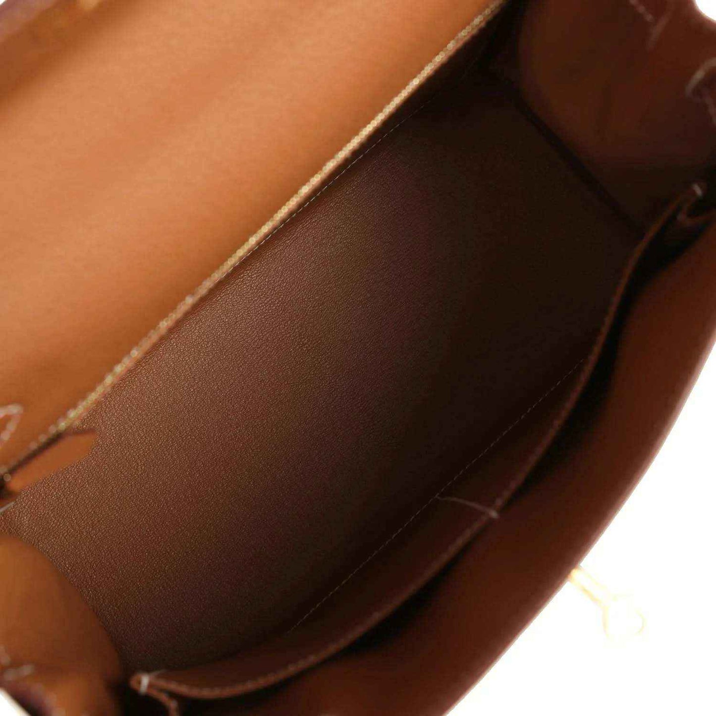 Tan leather handbag interior with smooth lining and stitched seam