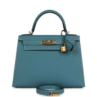 Blue leather Kelly handbag with top handles, gold lock, and removable shoulder strap.