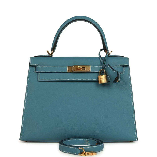 Blue leather Kelly handbag with top handles, gold lock, and removable shoulder strap.