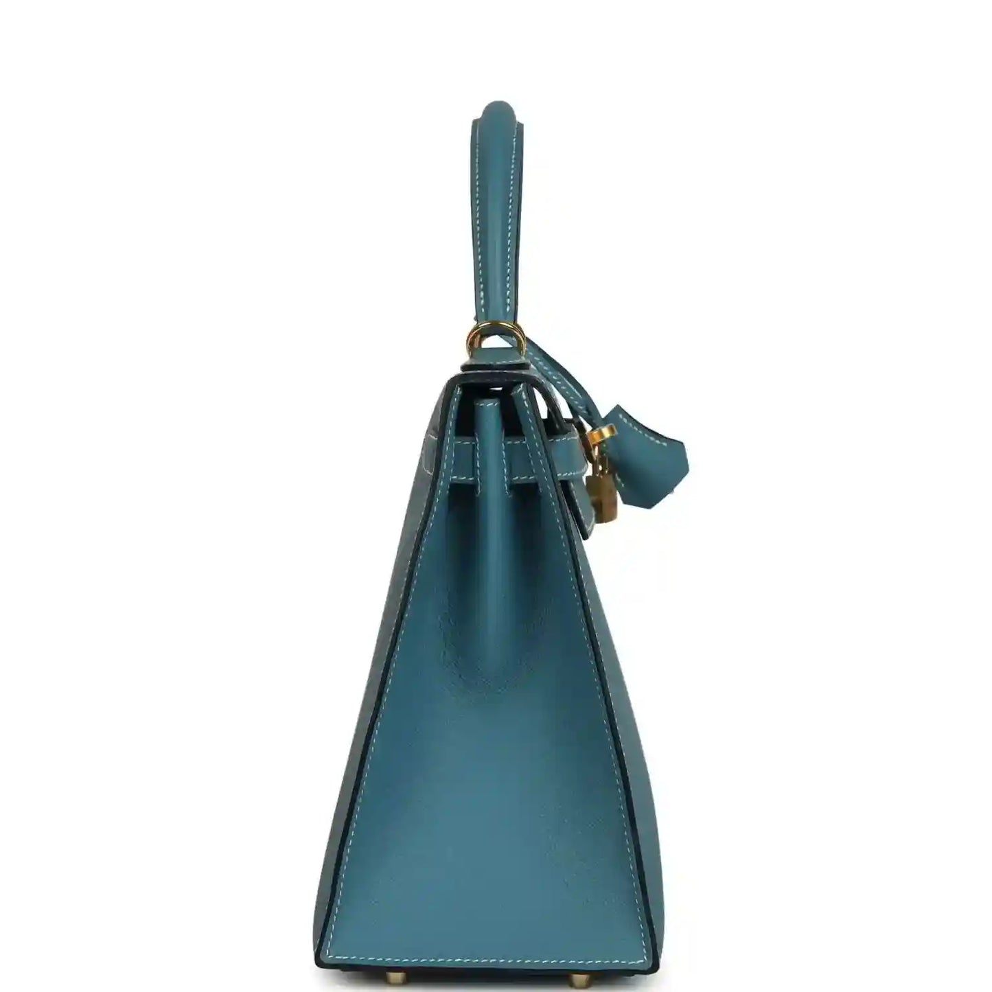 Blue leather handbag with upright silhouette, top handle, and attached leather strap loop.