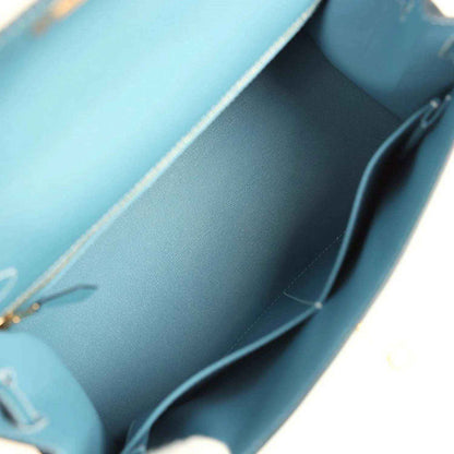 Blue leather interior of Kelly handbag with seam lines and inner compartment edge.