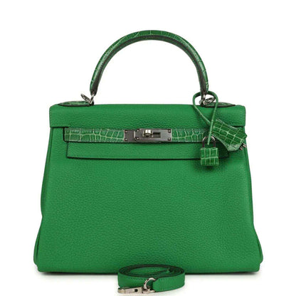 Green leather handbag with crocodile-style front trim and top handle