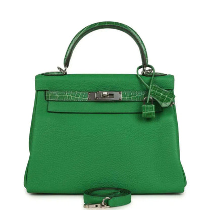 Green leather handbag with crocodile-style front trim and top handle