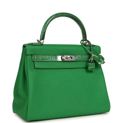 Green leather handbag with croc-pattern flap, front lock plate, and shoulder strap