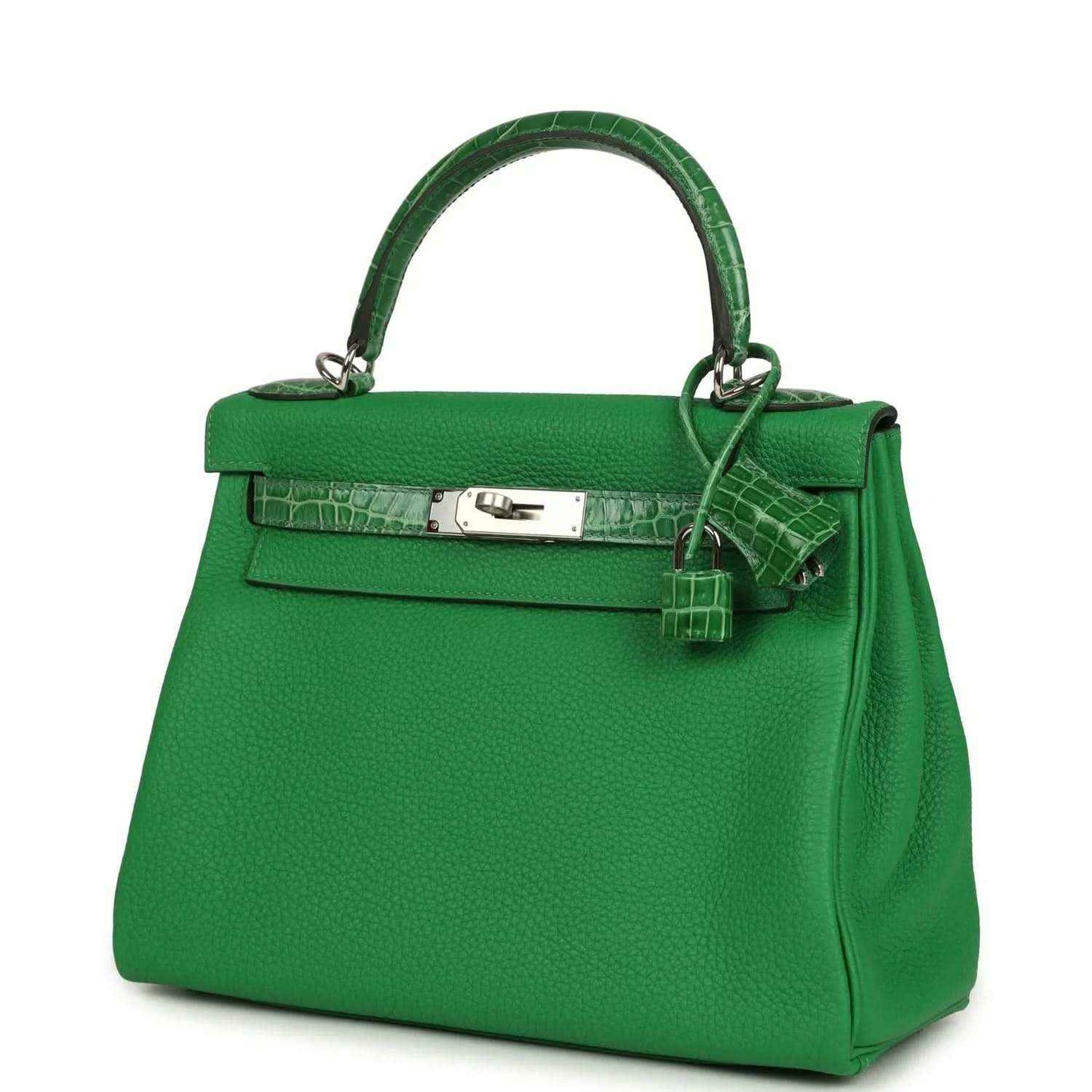 Green leather handbag with front flap, croc-pattern band, and hanging strap charm