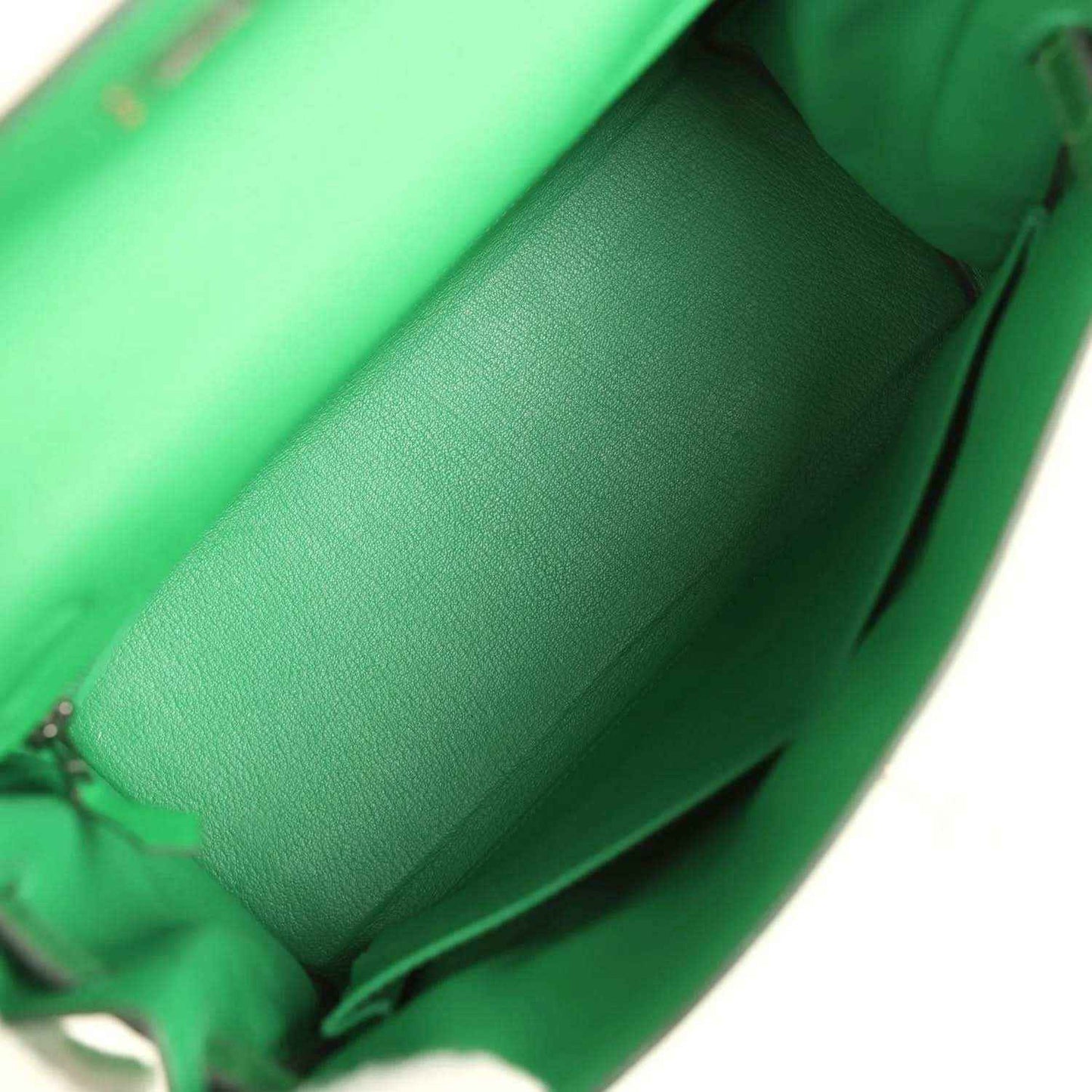 Green leather handbag interior with folded lining and inner side wall