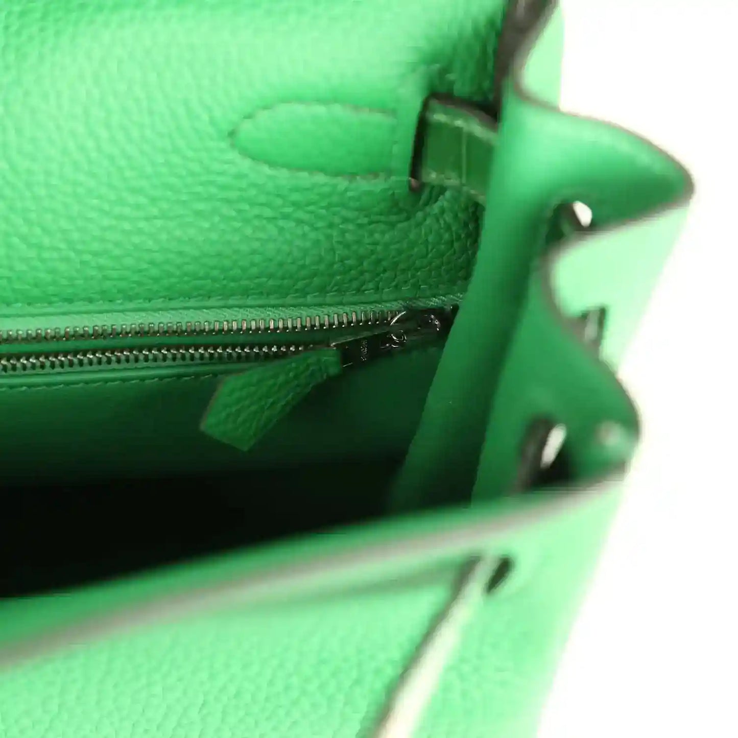 Green leather handbag interior pocket with zip and small pull tab