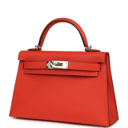 Red mini Kelly top-handle bag front view with flap clasp and silver-tone hardware