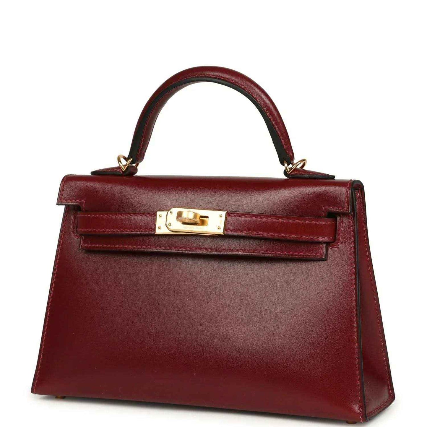 Red leather handbag with top handle, gold lock plate, and front strap detail.