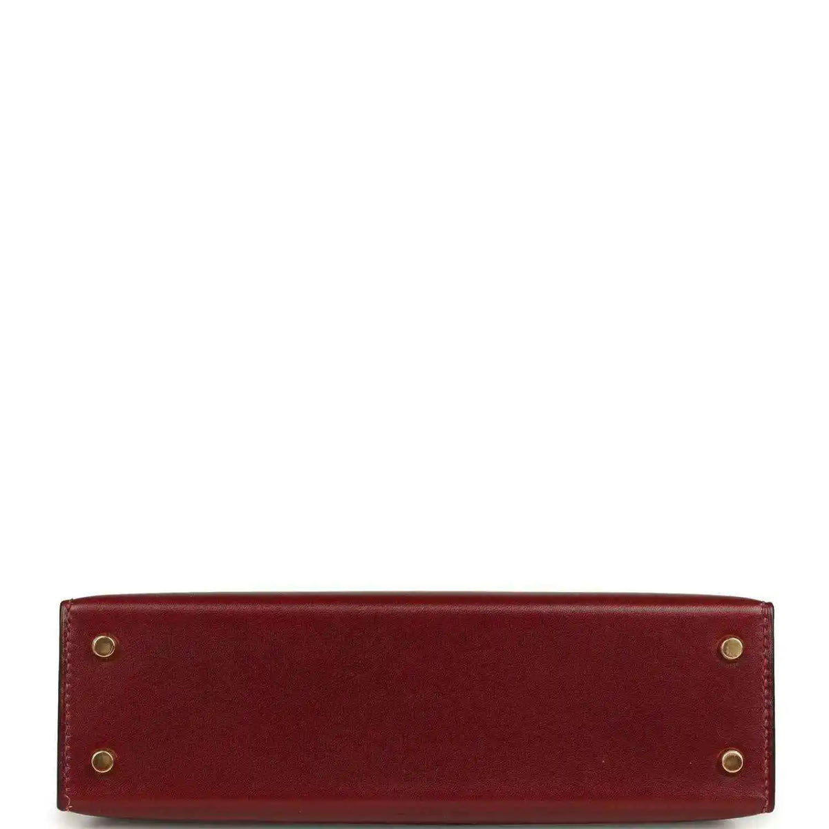 Red leather handbag back panel with four gold-toned rivets.