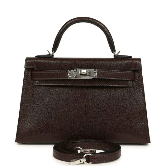 Small leather handbag with front flap, silver-tone clasp, and matching strap