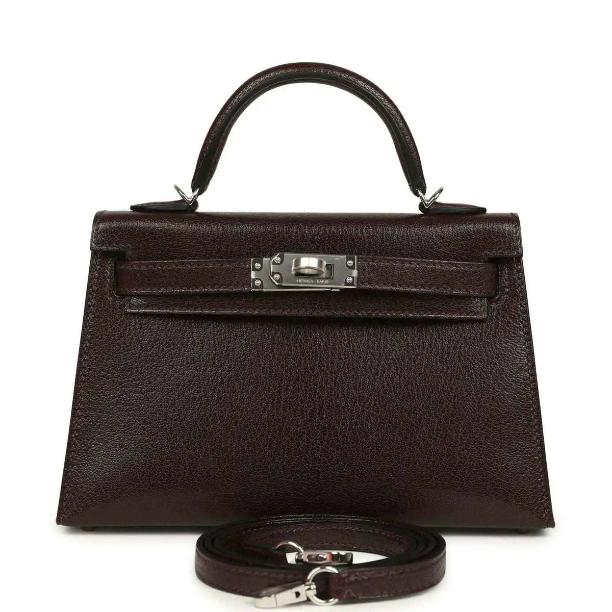Small leather handbag with front flap, silver-tone clasp, and matching strap