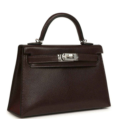 Small leather handbag with top handle, front flap, and silver-tone clasp