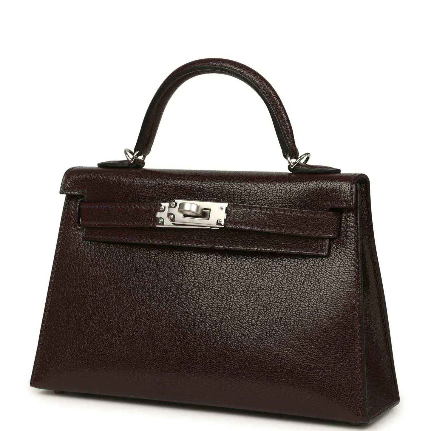 Small leather handbag angled front view with top handle and silver-tone clasp