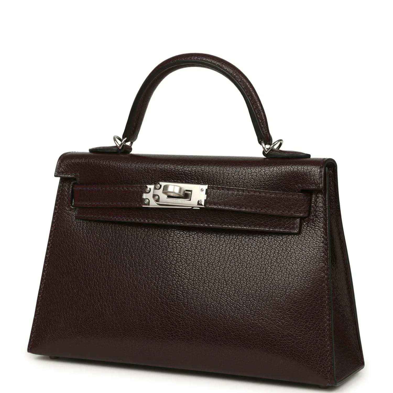Small leather handbag angled front view with top handle and silver-tone clasp