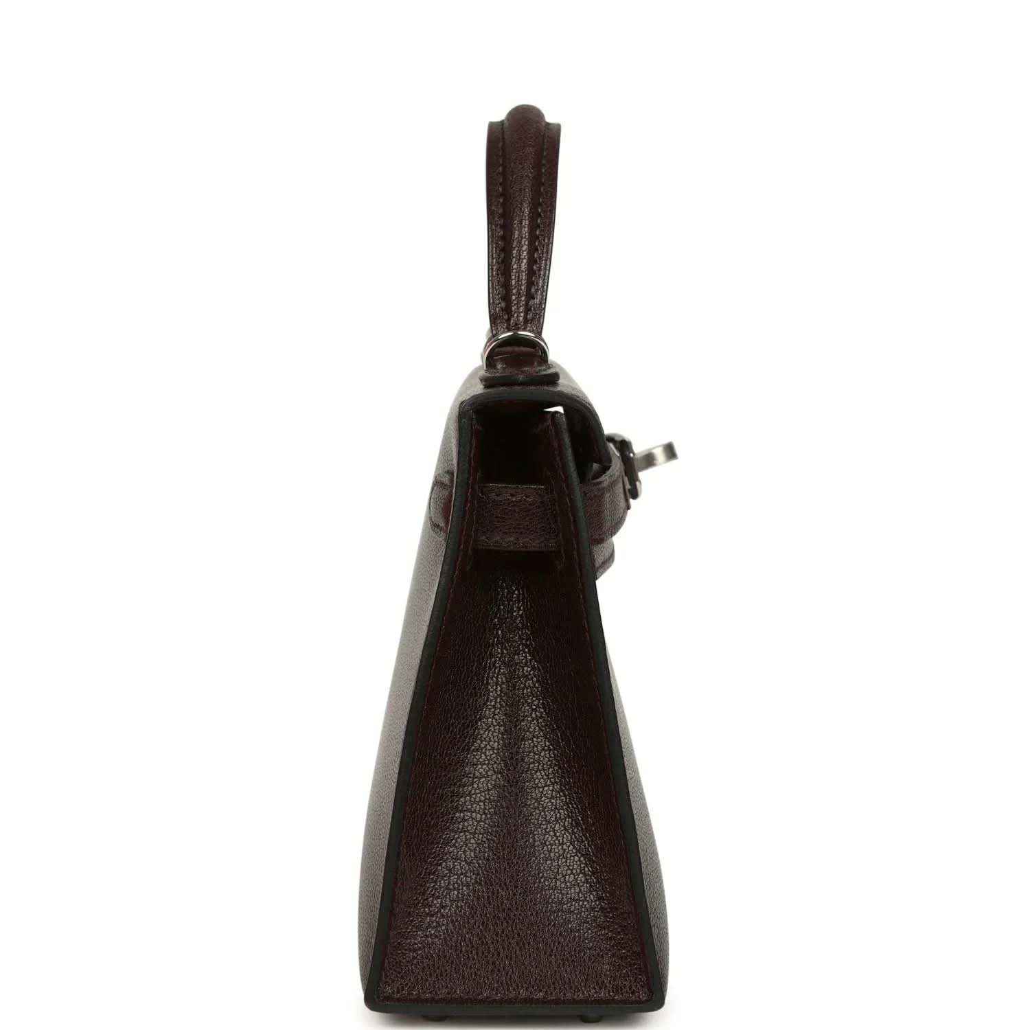 Small leather handbag side view with top handle and clasp hardware