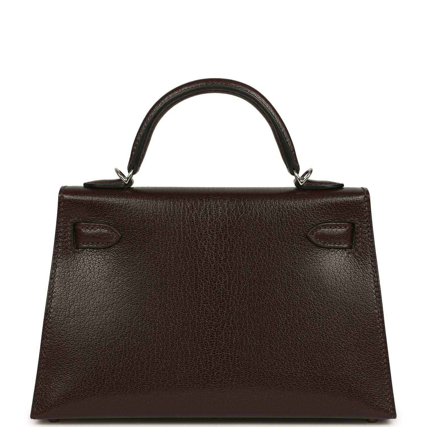 Small leather handbag back with top handle and stitched decorative tabs