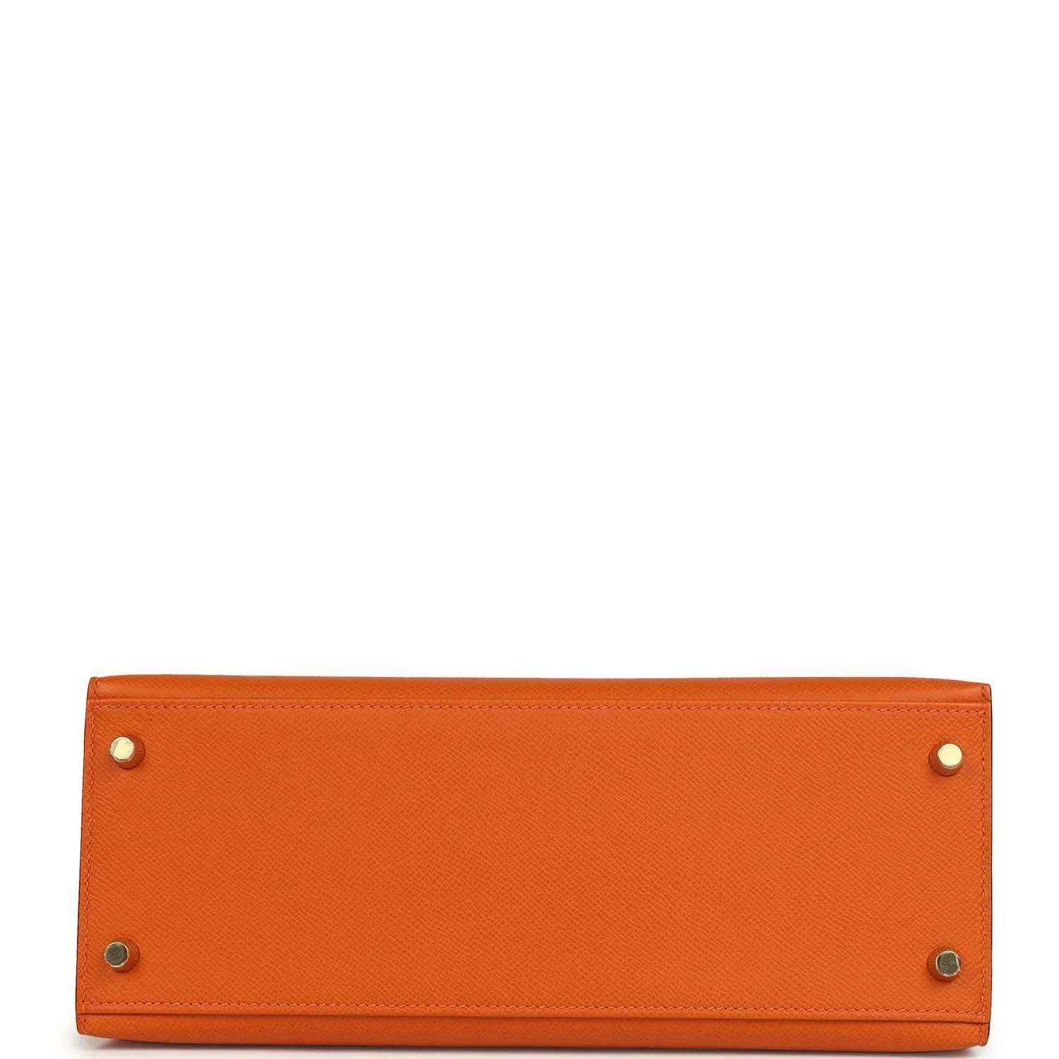 Orange leather Kelly bag base with metal corner hardware rivets.
