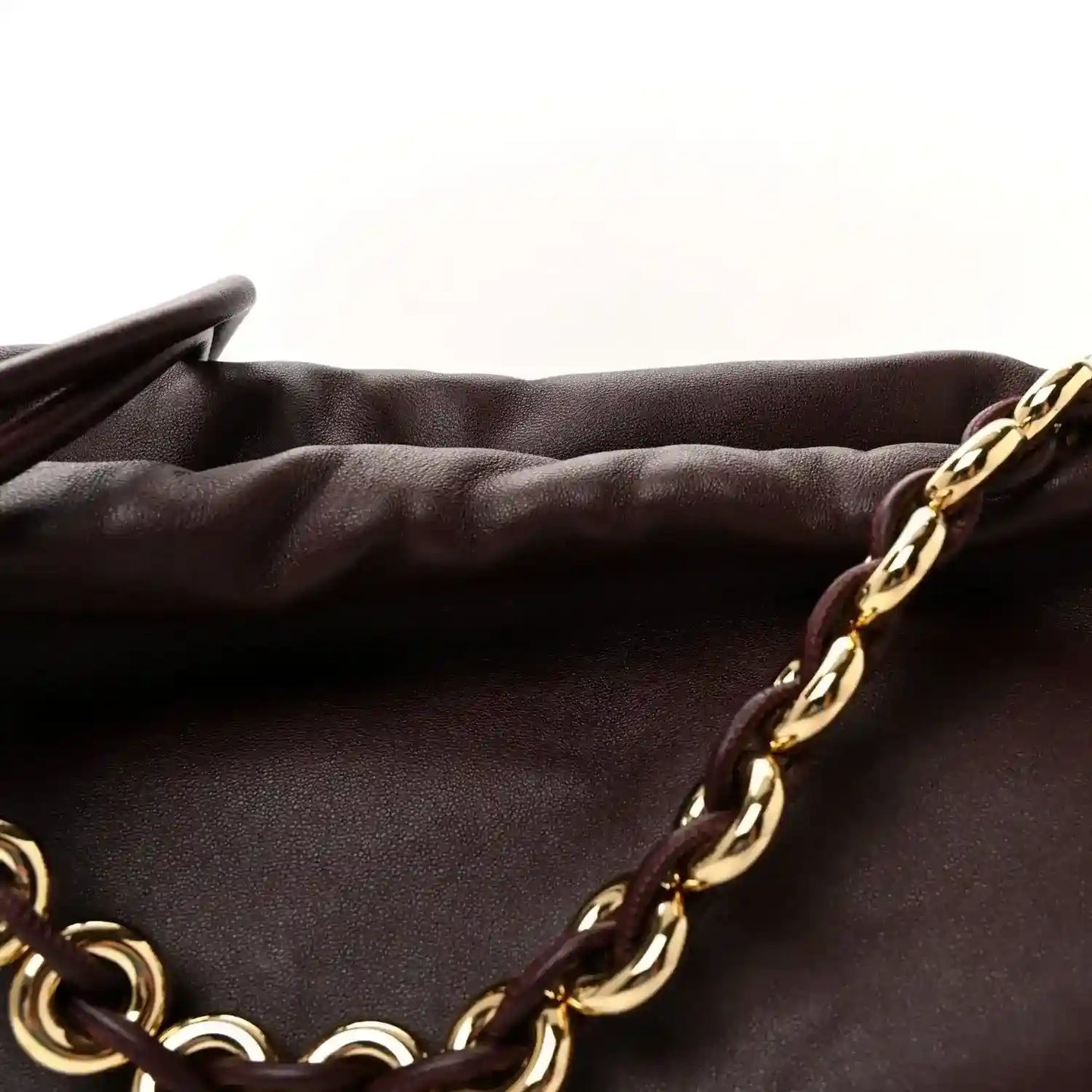 Dark burgundy nappa clutch with gold chain strap and knot clasp detail