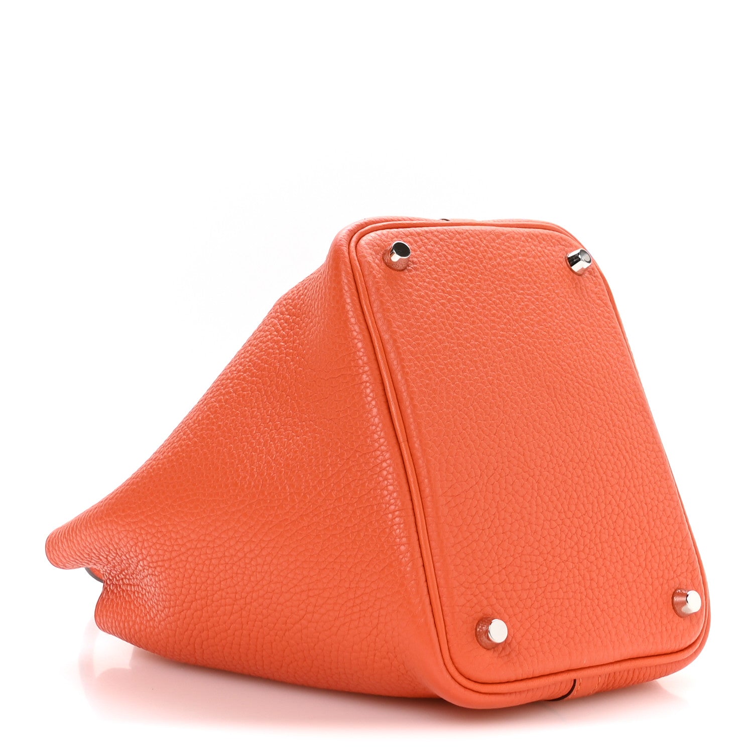 Orange pebbled leather handbag side view with metal studs and top zipper seam