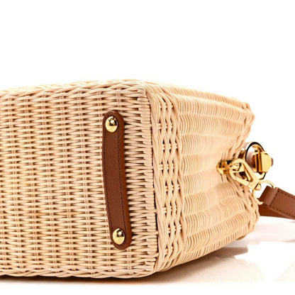 Tan rattan handbag side with brown leather tab and gold strap clasp hardware