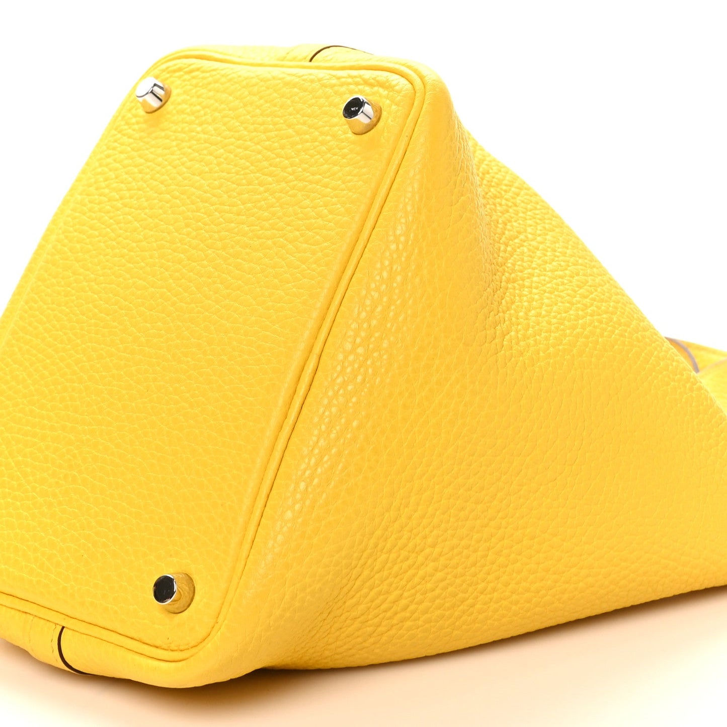 Lime yellow pebbled leather tote with corner buttons and long zipper seam