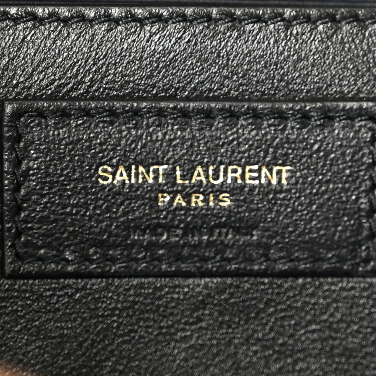 Black leather inner patch with 'SAINT LAURENT PARIS' text