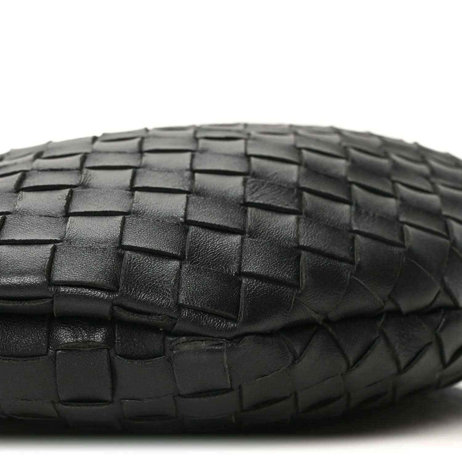 Bottega Veneta intrecciato nappa bag side in black with woven pattern close-up.