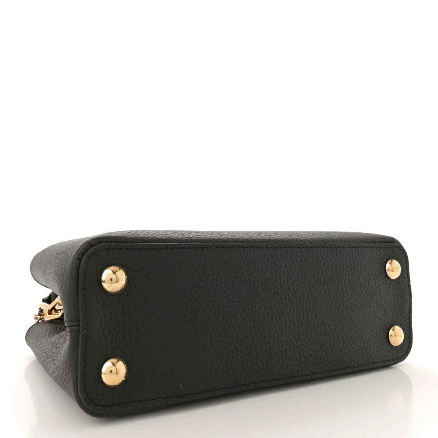 Black leather bag with gold stud feet on base corners, side view