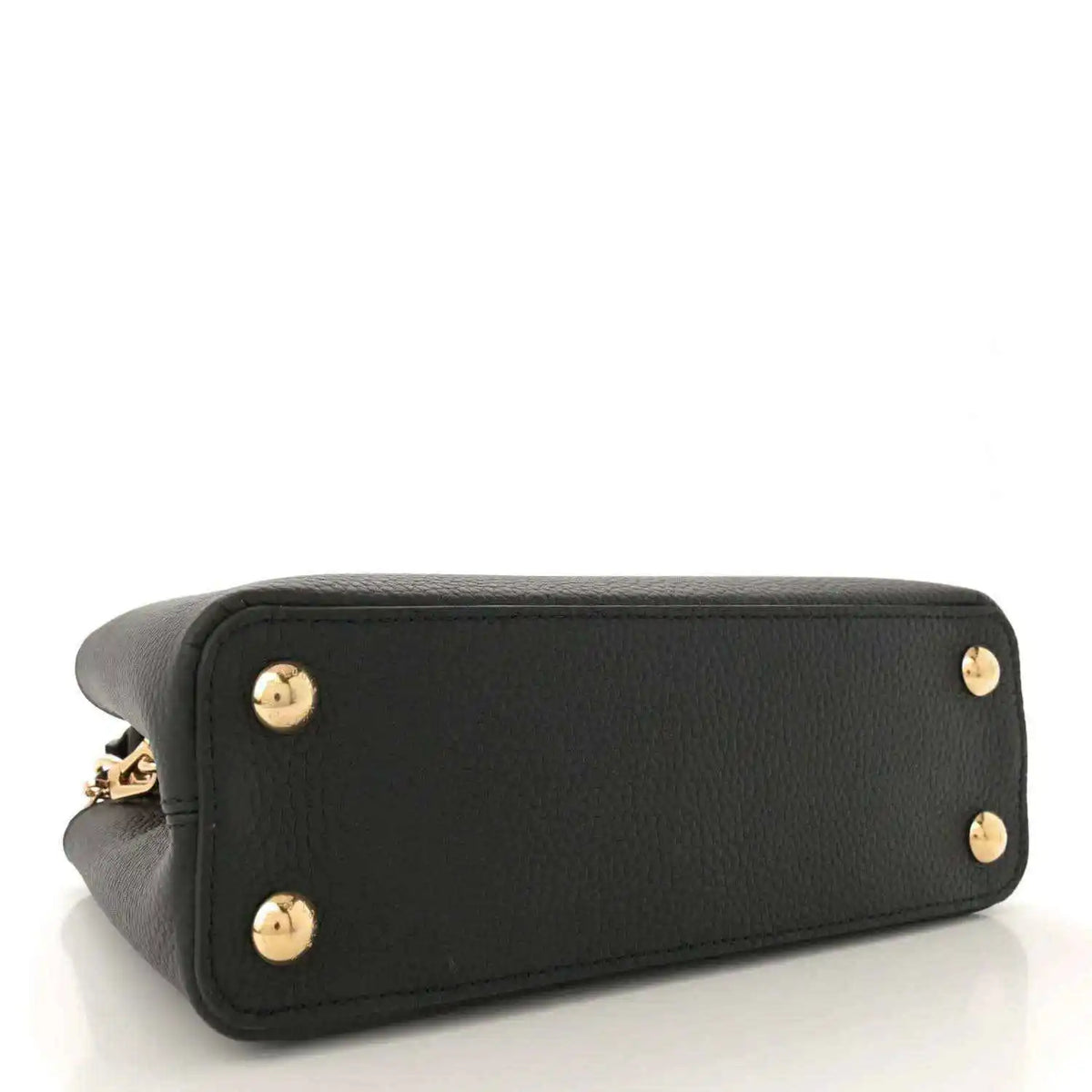 Black leather bag with gold stud feet on base corners, side view