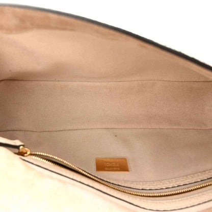 Fendi baguette handbag interior close-up with gold zipper and light beige lining
