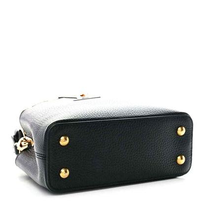 Black leather mini handbag with gold button studs and top handle