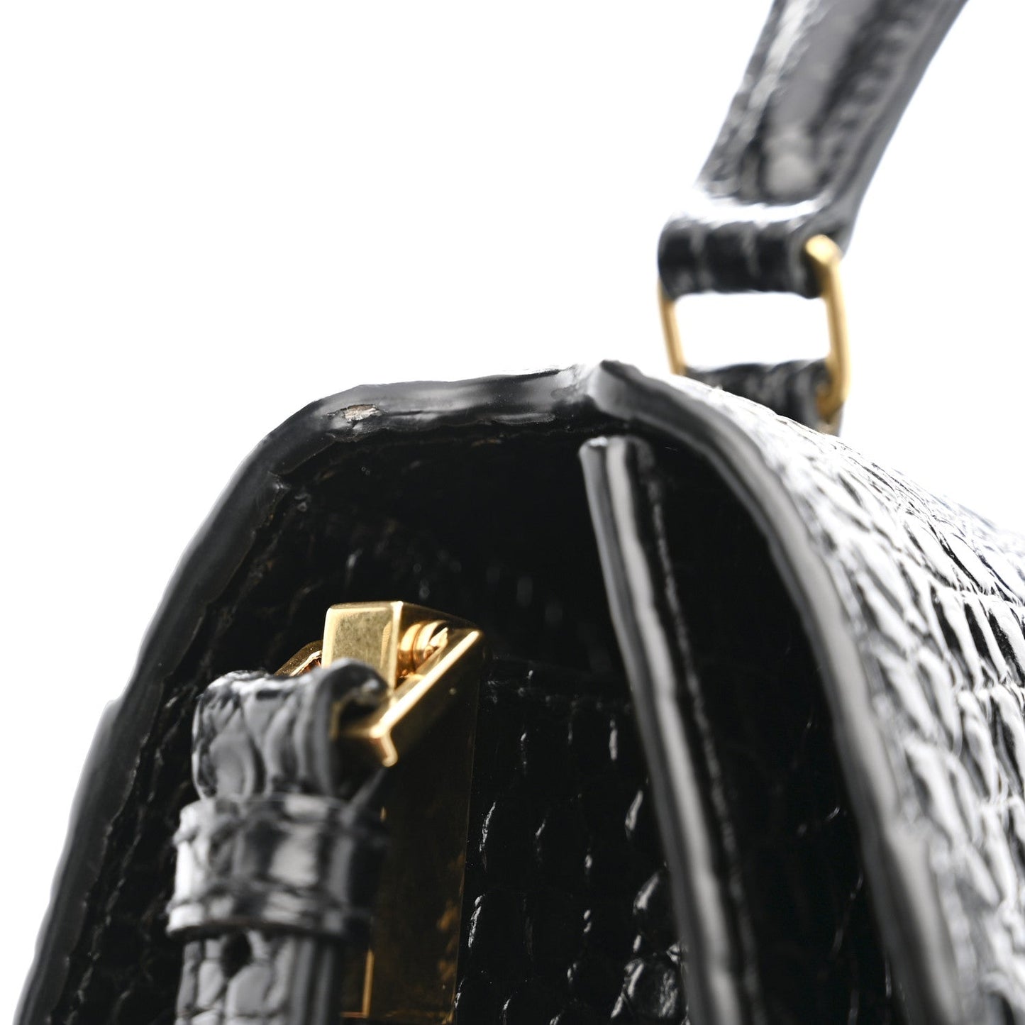 Black crocodile-embossed top handle bag with gold clasp and glossy interior