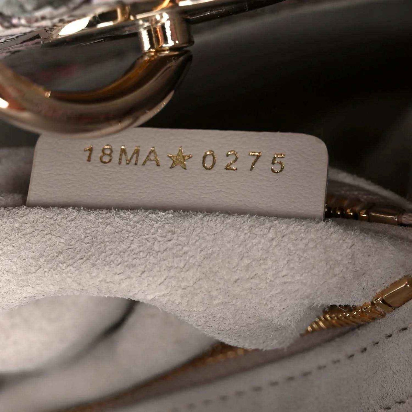Handbag interior style tag reading 18MA★0275 under stitched lining